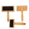 Two rectangular pet brushes made of bamboo show metal pin bristles on a black base, while one brush shows the back facing the viewer. The brushes are displayed against a white background.