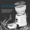 The exploded view of a white automatic pet feeding machine with splashes of water superimposed on the foreground, a dark grey background, and blue text describing product features.